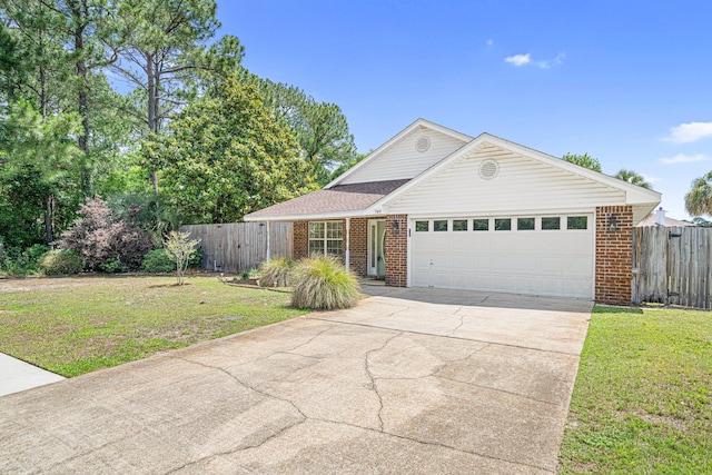749 Randall Roberts Rd, Fort Walton Beach, FL 32547 - view of front of house featuring a garage, brick siding, and driveway