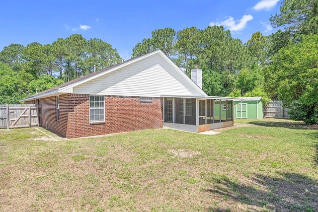 749 Randall Roberts Rd, Fort Walton Beach, FL 32547 - back of house with a sunroom, a chimney, brick siding, and a gate