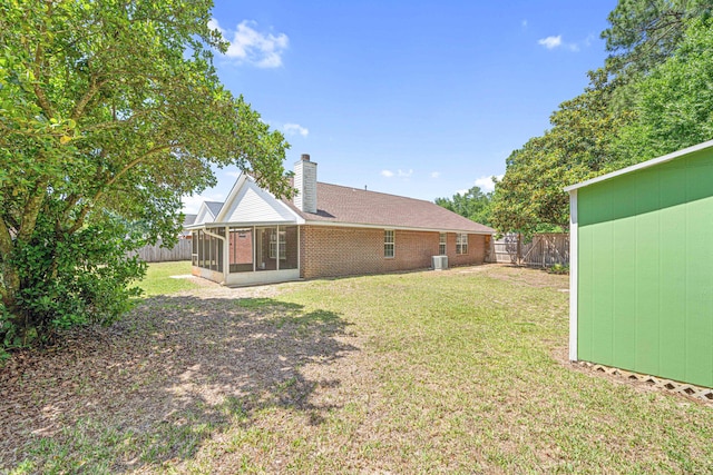 749 Randall Roberts Rd, Fort Walton Beach, FL 32547 - rear view of house with a sunroom, a chimney, and brick siding