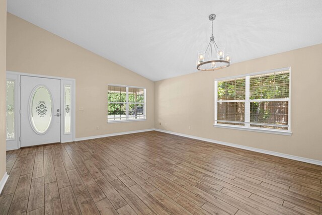749 Randall Roberts Rd, Fort Walton Beach, FL 32547 - entrance foyer featuring a chandelier, baseboards, wood finished floors, and vaulted ceiling