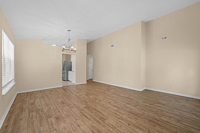749 Randall Roberts Rd, Fort Walton Beach, FL 32547 - spare room with a chandelier, light wood finished floors, and healthy amount of natural light