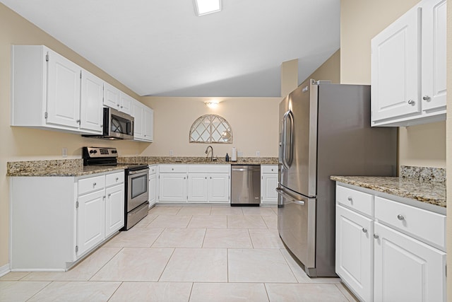 749 Randall Roberts Rd, Fort Walton Beach, FL 32547 - kitchen with appliances with stainless steel finishes, a sink, light stone countertops, white cabinetry, and light tile patterned floors
