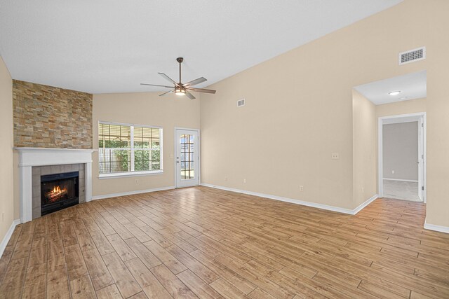 749 Randall Roberts Rd, Fort Walton Beach, FL 32547 - unfurnished living room featuring ceiling fan, light wood-style flooring, a fireplace, baseboards, and high vaulted ceiling