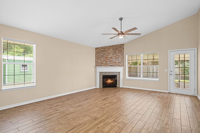 749 Randall Roberts Rd, Fort Walton Beach, FL 32547 - unfurnished living room featuring lofted ceiling, ceiling fan, light wood-style floors, a fireplace, and baseboards