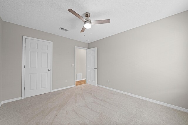 749 Randall Roberts Rd, Fort Walton Beach, FL 32547 - unfurnished bedroom with carpet flooring, baseboards, a textured ceiling, and ceiling fan