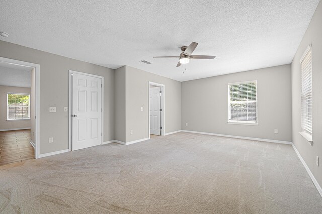 749 Randall Roberts Rd, Fort Walton Beach, FL 32547 - unfurnished bedroom featuring light colored carpet, a textured ceiling, baseboards, and ceiling fan