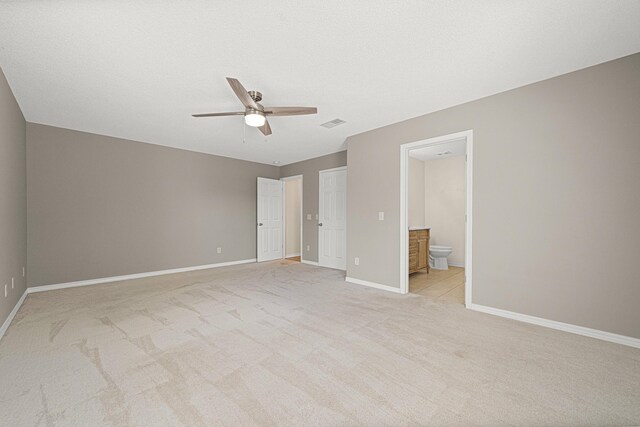 749 Randall Roberts Rd, Fort Walton Beach, FL 32547 - unfurnished bedroom with light carpet, baseboards, ensuite bath, and a ceiling fan