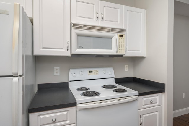 1501 N Partin Dr Unit 264, Niceville, FL 32578 - kitchen with white appliances, dark countertops, and white cabinetry