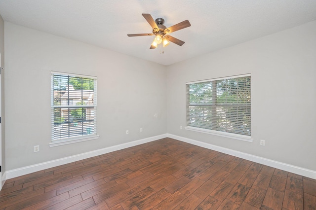 1501 N Partin Dr Unit 264, Niceville, FL 32578 - spare room featuring dark wood-style floors, a ceiling fan, and baseboards