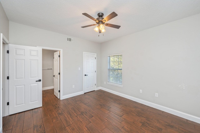 1501 N Partin Dr Unit 264, Niceville, FL 32578 - unfurnished bedroom with dark wood-type flooring, baseboards, ceiling fan, and a textured ceiling