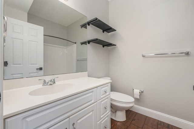 1501 N Partin Dr Unit 264, Niceville, FL 32578 - full bath featuring wood finished floors, baseboards, toilet, vanity, and a shower
