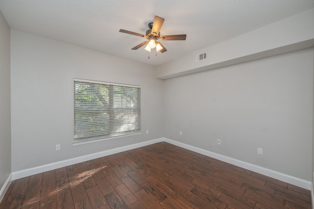 1501 N Partin Dr Unit 264, Niceville, FL 32578 - spare room featuring dark wood-style flooring, a ceiling fan, and baseboards