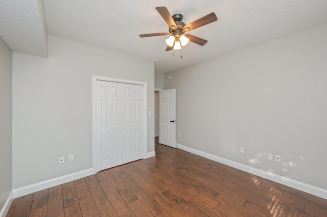 1501 N Partin Dr Unit 264, Niceville, FL 32578 - unfurnished bedroom featuring dark wood-type flooring, baseboards, a closet, and a ceiling fan