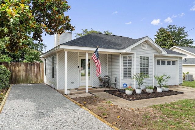 407 Apple Dr, Crestview, FL 32536 - view of front of property featuring an attached garage, roof with shingles, central air condition unit, a chimney, and driveway