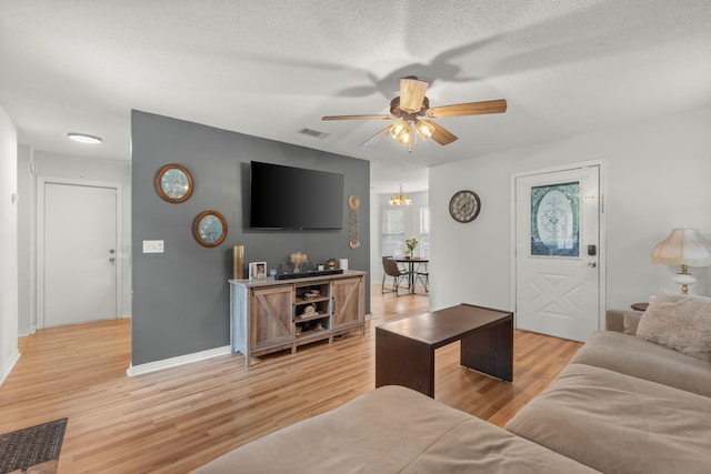 407 Apple Dr, Crestview, FL 32536 - living area with a ceiling fan, light wood-style floors, a textured ceiling, and baseboards