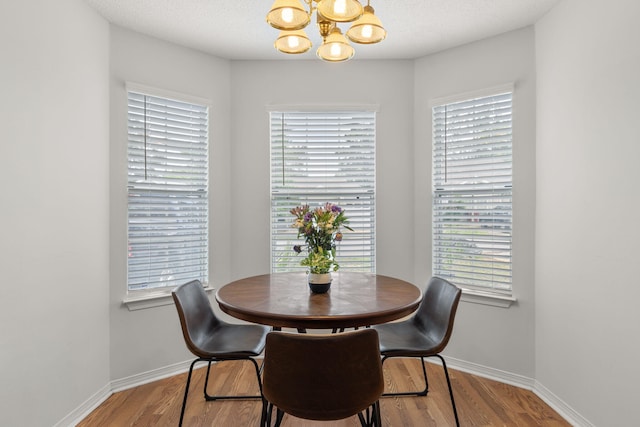 407 Apple Dr, Crestview, FL 32536 - dining room with a chandelier, baseboards, and wood finished floors