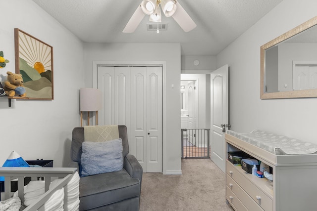 407 Apple Dr, Crestview, FL 32536 - bedroom with light colored carpet, a closet, ceiling fan, and a textured ceiling