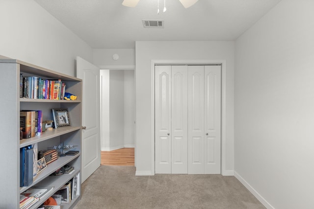 407 Apple Dr, Crestview, FL 32536 - bedroom with carpet, a closet, baseboards, and a ceiling fan