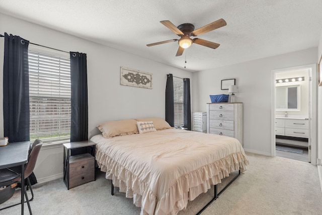 407 Apple Dr, Crestview, FL 32536 - bedroom featuring light colored carpet, baseboards, a textured ceiling, ensuite bathroom, and ceiling fan
