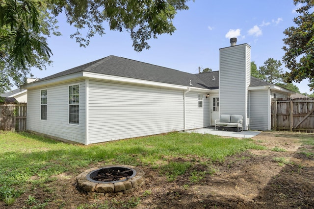 407 Apple Dr, Crestview, FL 32536 - back of house featuring an outdoor fire pit, a patio, a chimney, and roof with shingles