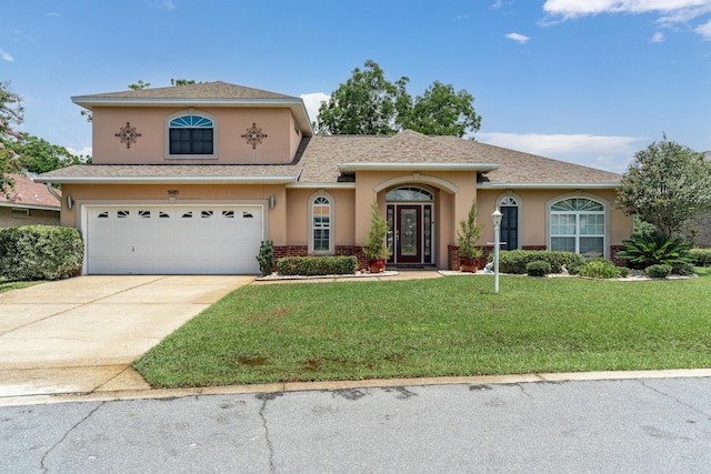 1961 Chesapeake Rdg, Fort Walton Beach, FL 32547 - view of front of house with stucco siding, an attached garage, a front lawn, driveway, and roof with shingles