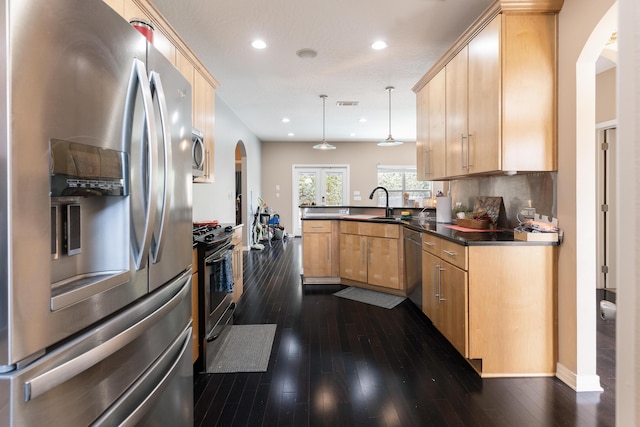 1961 Chesapeake Rdg, Fort Walton Beach, FL 32547 - kitchen with appliances with stainless steel finishes, arched walkways, a peninsula, dark countertops, and dark wood finished floors