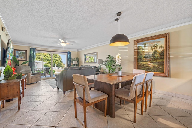 dining room featuring crown molding, ceiling fan, a textured ceiling, light tile patterned floors, and baseboards