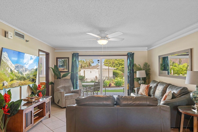 living room featuring a ceiling fan, crown molding, light tile patterned flooring, and a textured ceiling