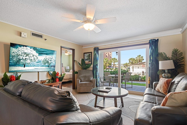living area featuring ornamental molding, ceiling fan, and a textured ceiling