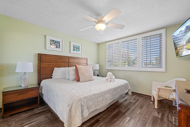 bedroom featuring a textured ceiling, wood finished floors, baseboards, and a ceiling fan
