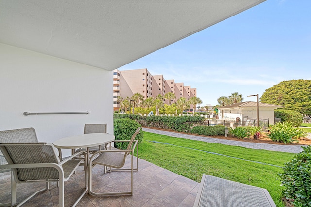 balcony with outdoor dining space and a patio
