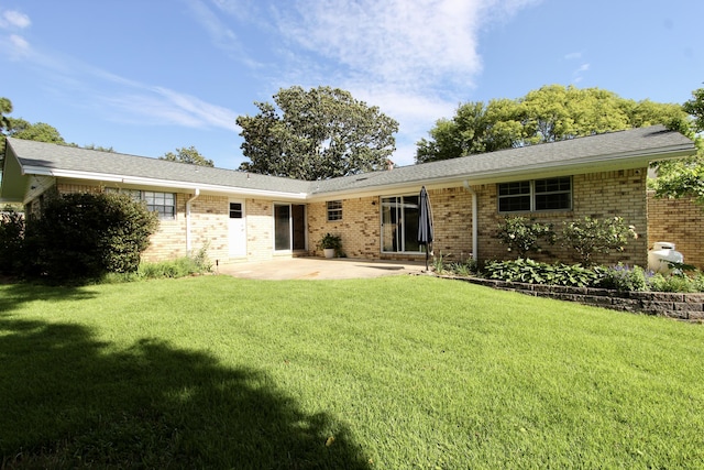 35 Birch Ave, Shalimar, FL 32579 - rear view of house featuring a patio, brick siding, and a yard