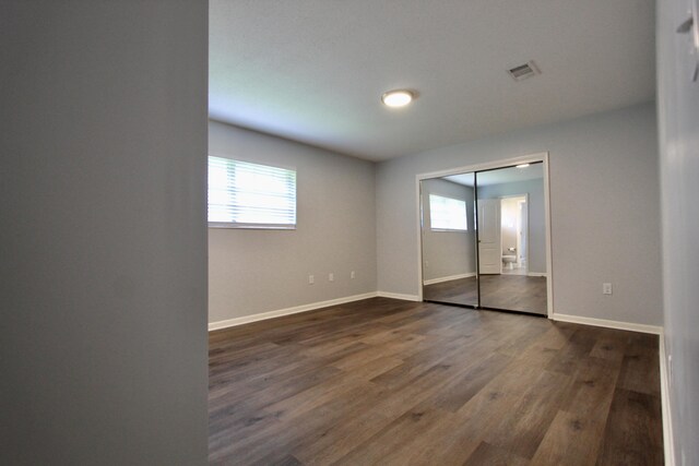 35 Birch Ave, Shalimar, FL 32579 - unfurnished bedroom featuring dark wood-style flooring and a closet