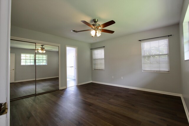 35 Birch Ave, Shalimar, FL 32579 - unfurnished bedroom with dark wood-style floors, a ceiling fan, and a closet