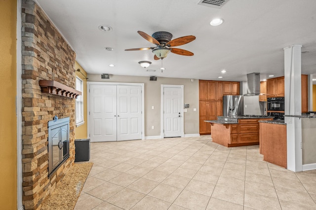 3 NE Windsor Ln, Fort Walton Beach, FL 32547 - kitchen with range hood, brown cabinets, ceiling fan, stainless steel refrigerator with ice dispenser, and a kitchen island