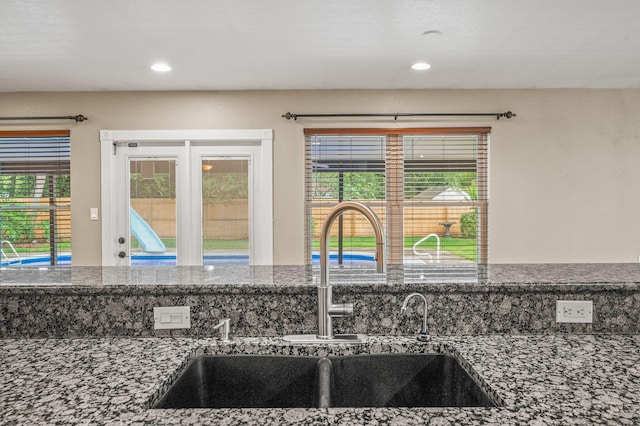 3 NE Windsor Ln, Fort Walton Beach, FL 32547 - kitchen view of a sink, recessed lighting, and dark stone counters