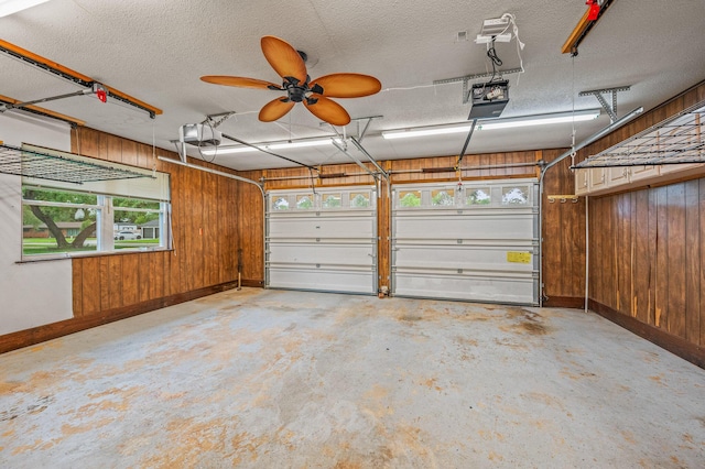 3 NE Windsor Ln, Fort Walton Beach, FL 32547 - garage featuring baseboards, wood walls, a garage door opener, and ceiling fan