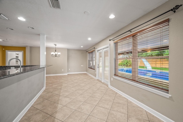 3 NE Windsor Ln, Fort Walton Beach, FL 32547 - spare room featuring a chandelier, light tile patterned flooring, recessed lighting, baseboards, and healthy amount of natural light