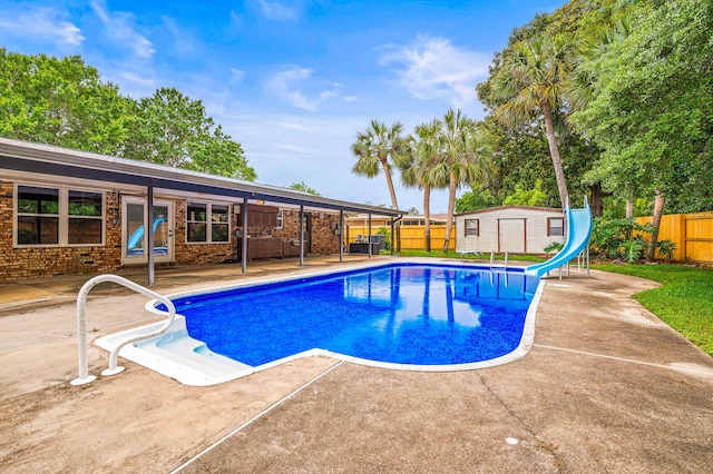 3 NE Windsor Ln, Fort Walton Beach, FL 32547 - view of pool with a water slide, a patio, and a fenced backyard