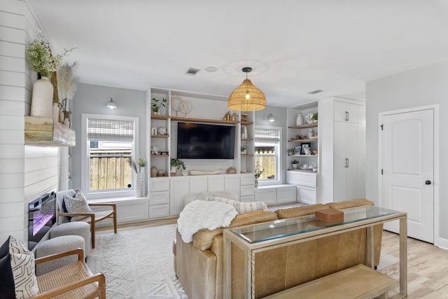 24 Bald Cypress Way, Santa Rosa Beach, FL 32459 - living area with light wood-type flooring, plenty of natural light, and a fireplace