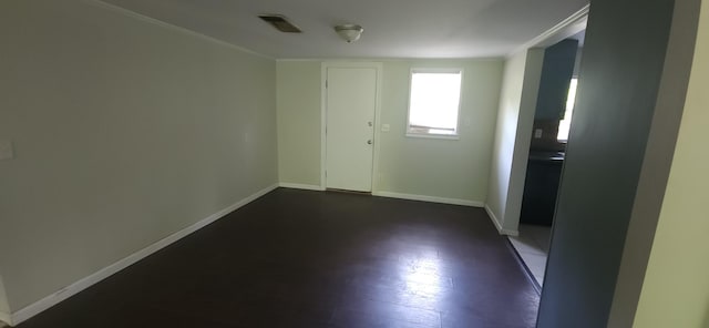 unfurnished room featuring baseboards