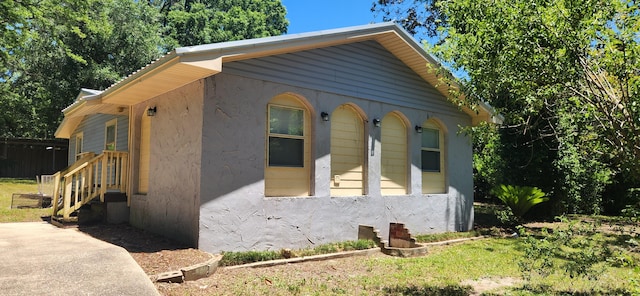 view of side of home featuring stucco siding