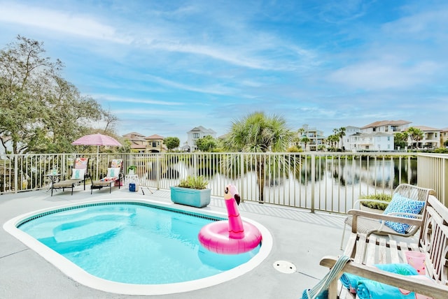 4634 Sunset Pointe, Destin, FL 32541 - view of pool featuring a water view, a residential view, and a patio