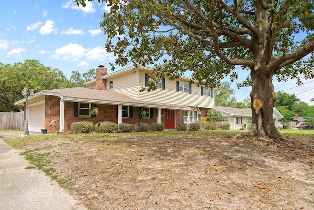 197 Country Club Rd, Shalimar, FL 32579 - traditional home with brick siding, an attached garage, a chimney, and fence