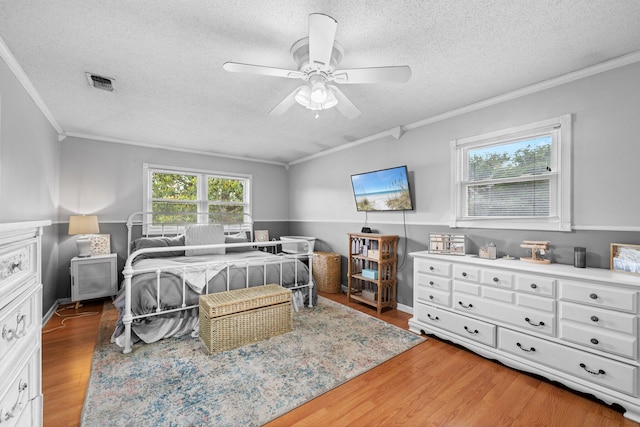 197 Country Club Rd, Shalimar, FL 32579 - bedroom with crown molding, wood finished floors, a textured ceiling, and ceiling fan