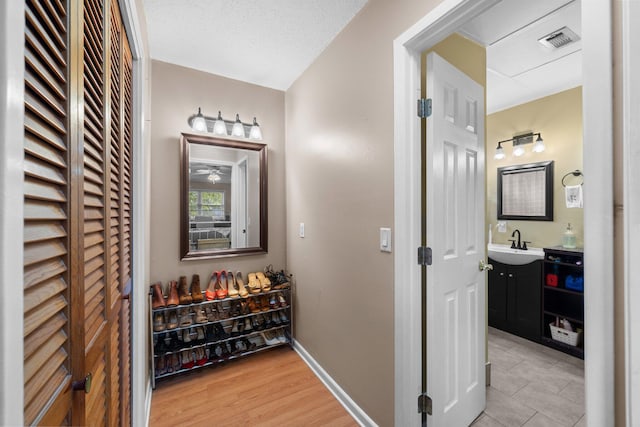 197 Country Club Rd, Shalimar, FL 32579 - corridor with a sink, baseboards, and light tile patterned floors
