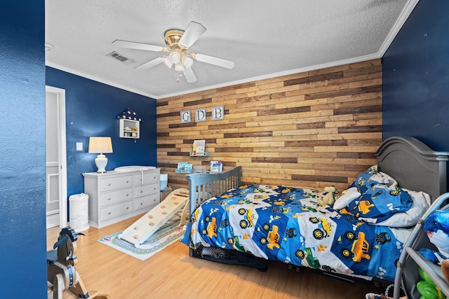 197 Country Club Rd, Shalimar, FL 32579 - bedroom with a textured ceiling, wood walls, wood finished floors, crown molding, and a ceiling fan