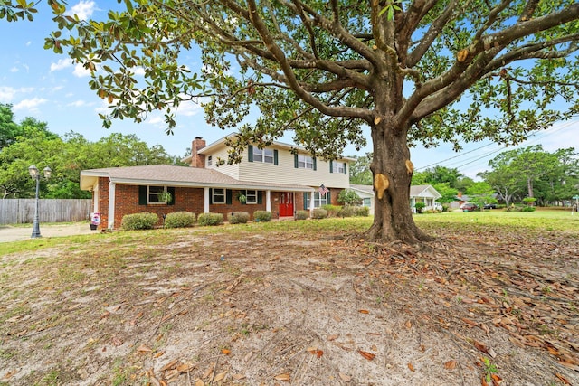 197 Country Club Rd, Shalimar, FL 32579 - traditional-style house featuring fence, brick siding, and a chimney