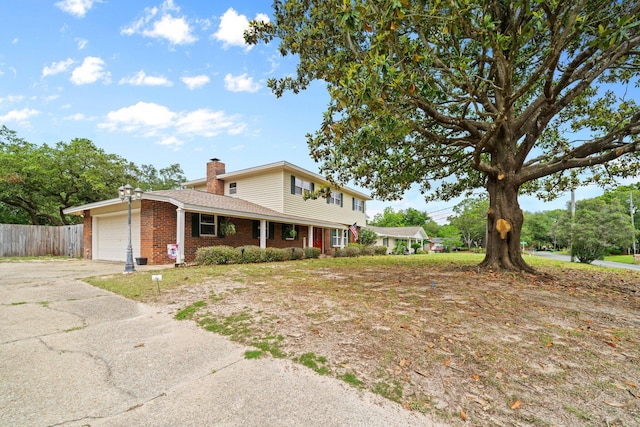 197 Country Club Rd, Shalimar, FL 32579 - traditional-style home with fence, an attached garage, concrete driveway, brick siding, and a chimney