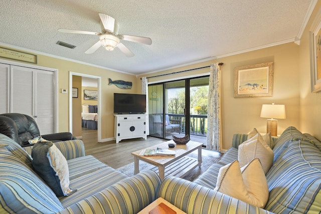 3755 Scenic Highway 98 Unit 1601, Destin, FL 32541 - living room with wood finished floors, a textured ceiling, ornamental molding, and a ceiling fan